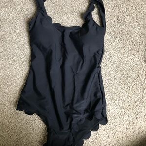 Black one piece swimsuit with scalloped edges